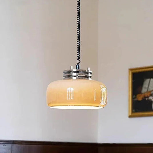The amber dome lit in a pale room beside a framed artwork