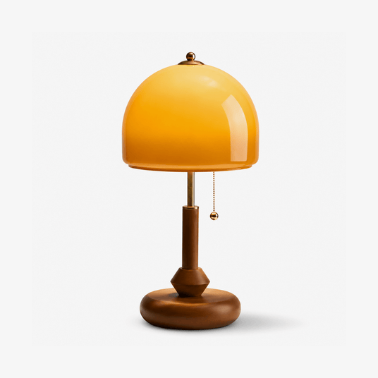 Dome table lamp with a glossy amber shade on a walnut base, plain background