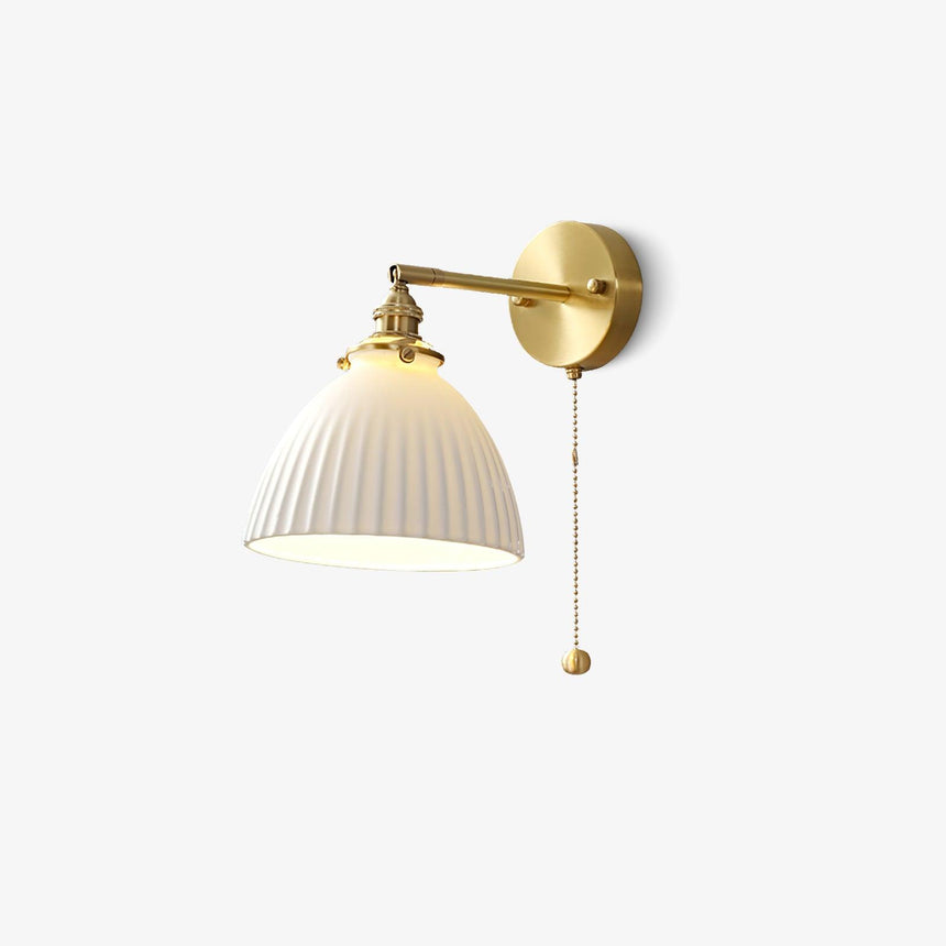 The sconce on a white background with its brass pull chain