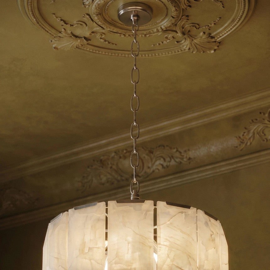 The stone drum hung below a plaster ceiling rose on a chain