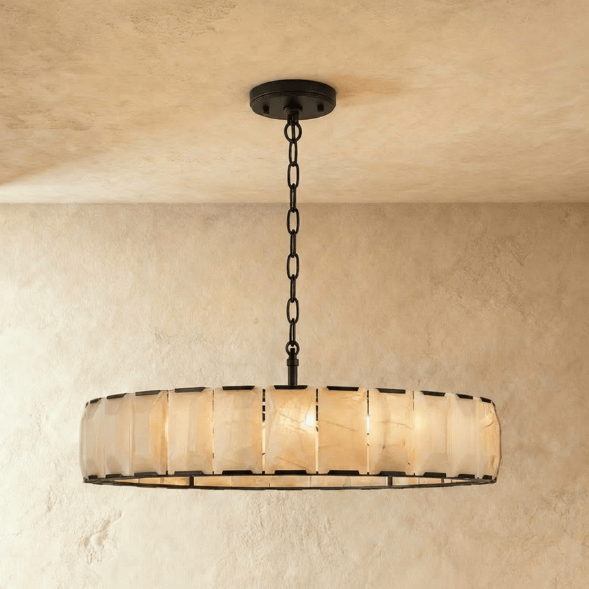 A low wide drum of alabaster panels in a black metal frame