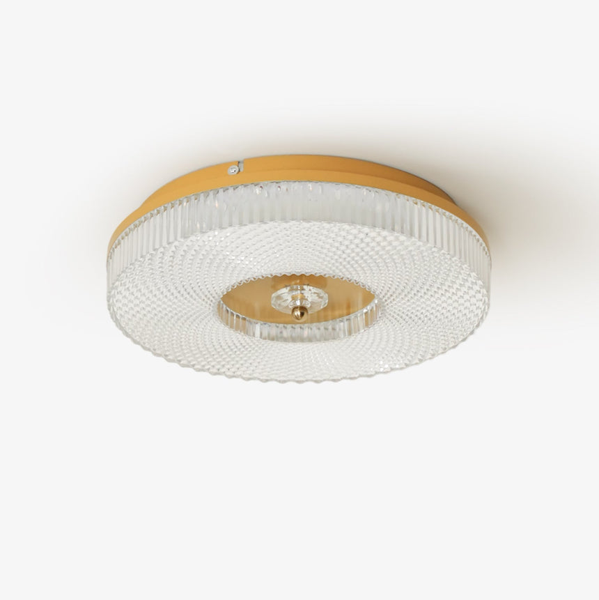 Ribbed drum ceiling light with a brass rim seen from below