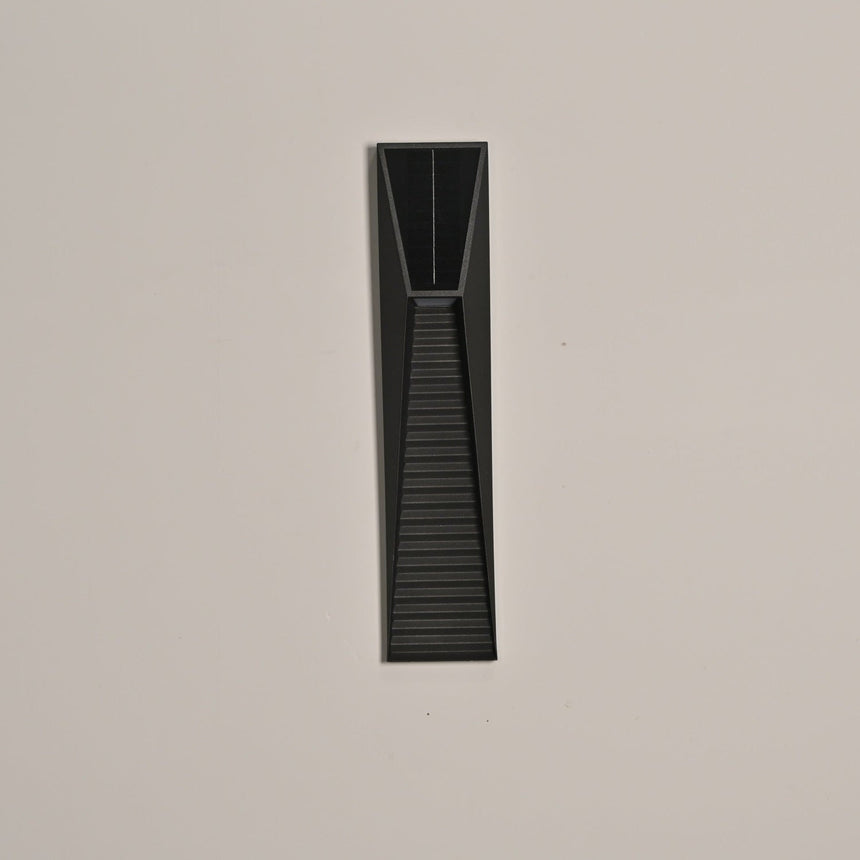 The light unlit on a warm beige wall, the solar cell set in the top section