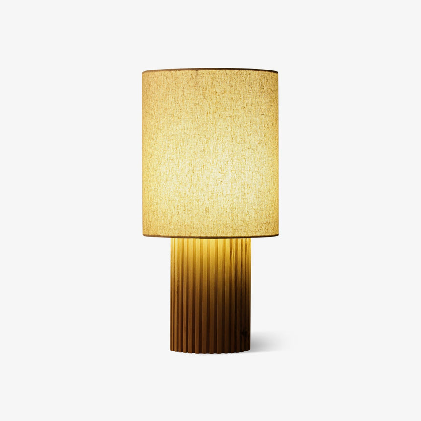 Entryway table lamp with a fluted natural wood base and a linen shade, plain background