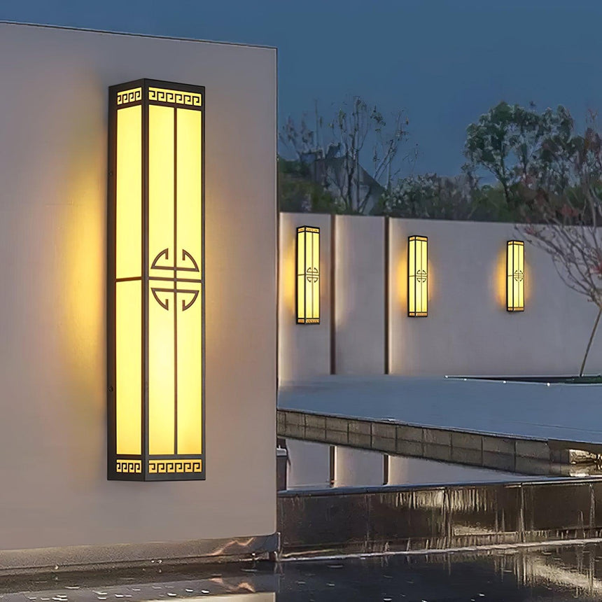 The tall lantern on a white garden wall above a reflecting pool, three more beyond
