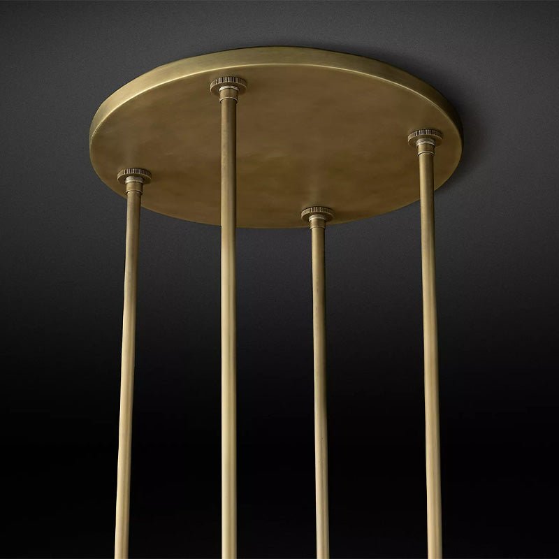 The brass ceiling plate with the four stems that carry the ring below it