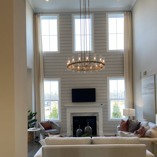 The brass ring lit in a tall room with a fireplace and windows on two levels
