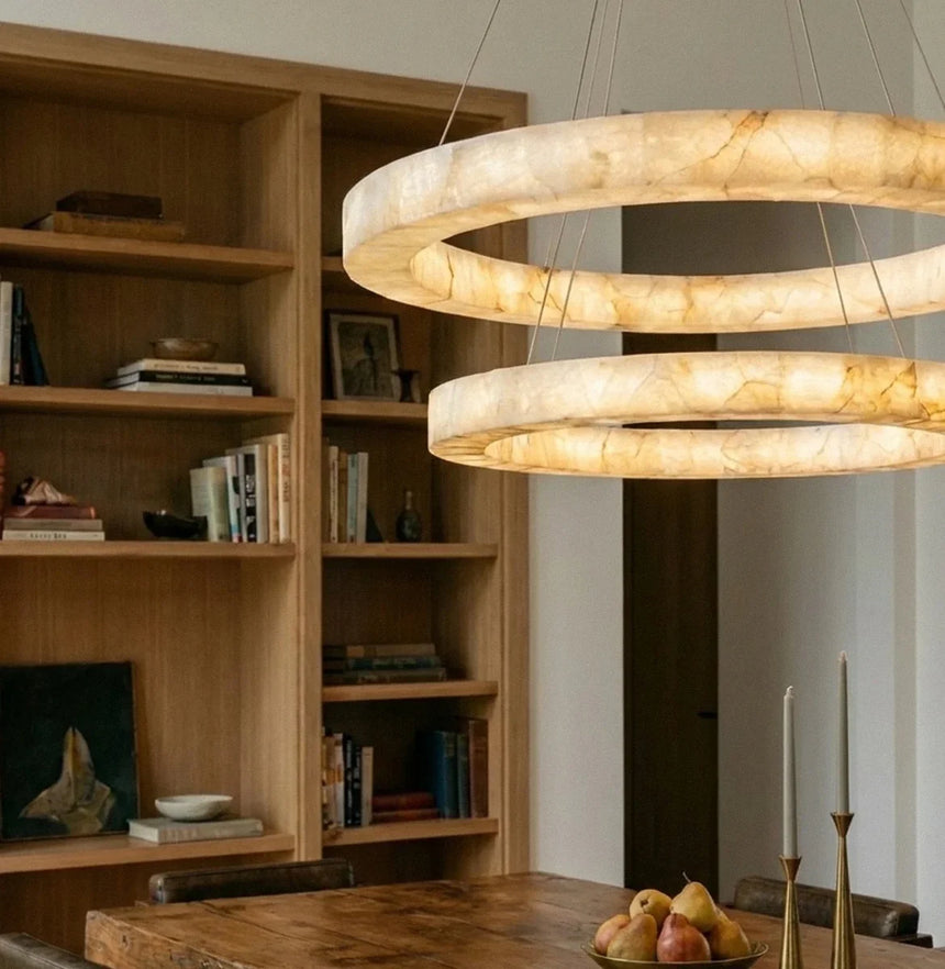 Two lit rings beside an open bookshelf wall above a kitchen counter