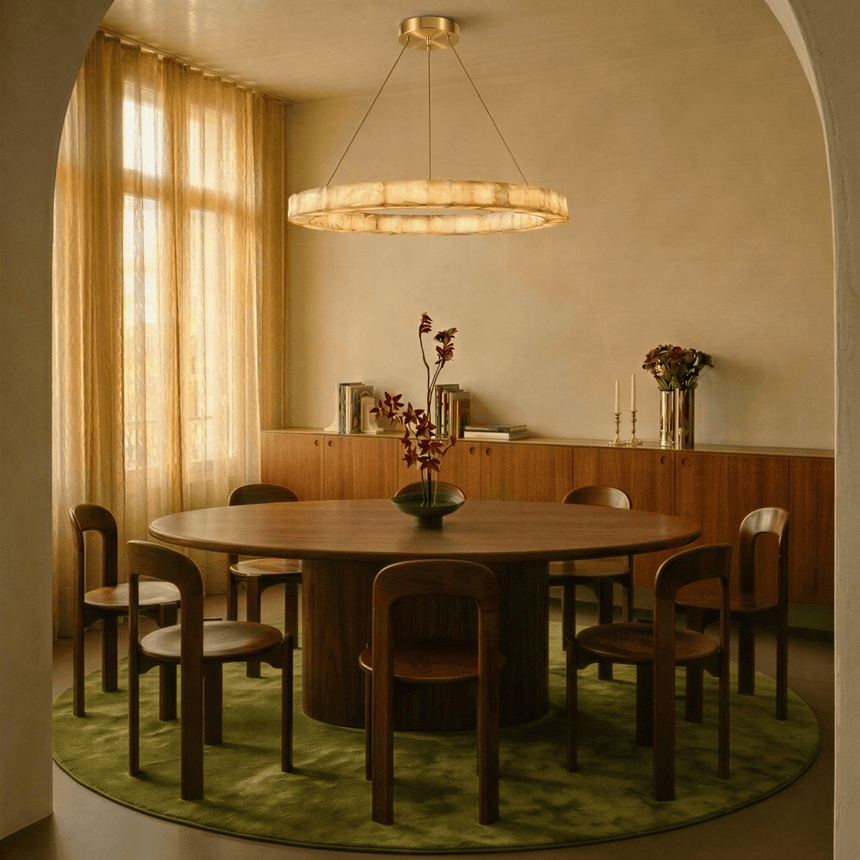 One lit ring above a round dining table standing on a green rug