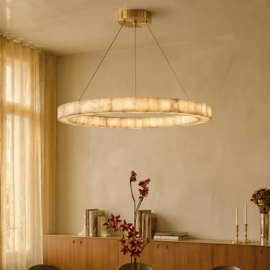 A lit ring above a sideboard set with flowers and candlesticks