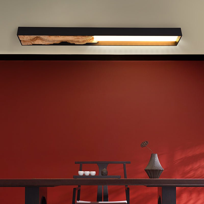 Bar mounted flat above a red wall and a low console holding two vessels