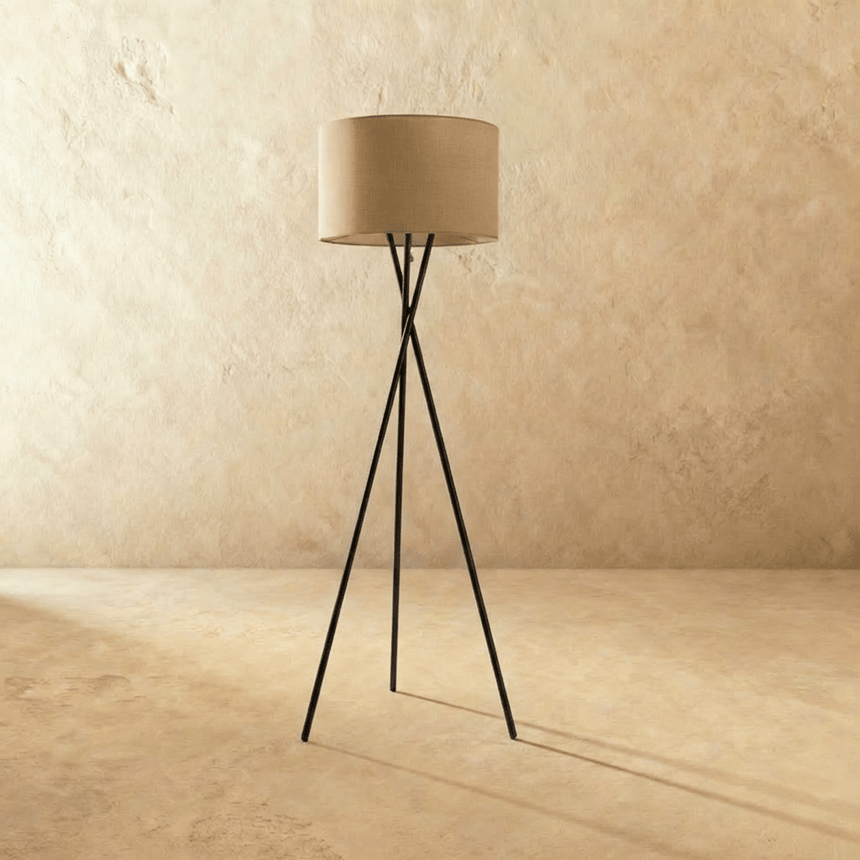 The crossed tripod with a flaxen fabric drum shade, legs crossing at mid height