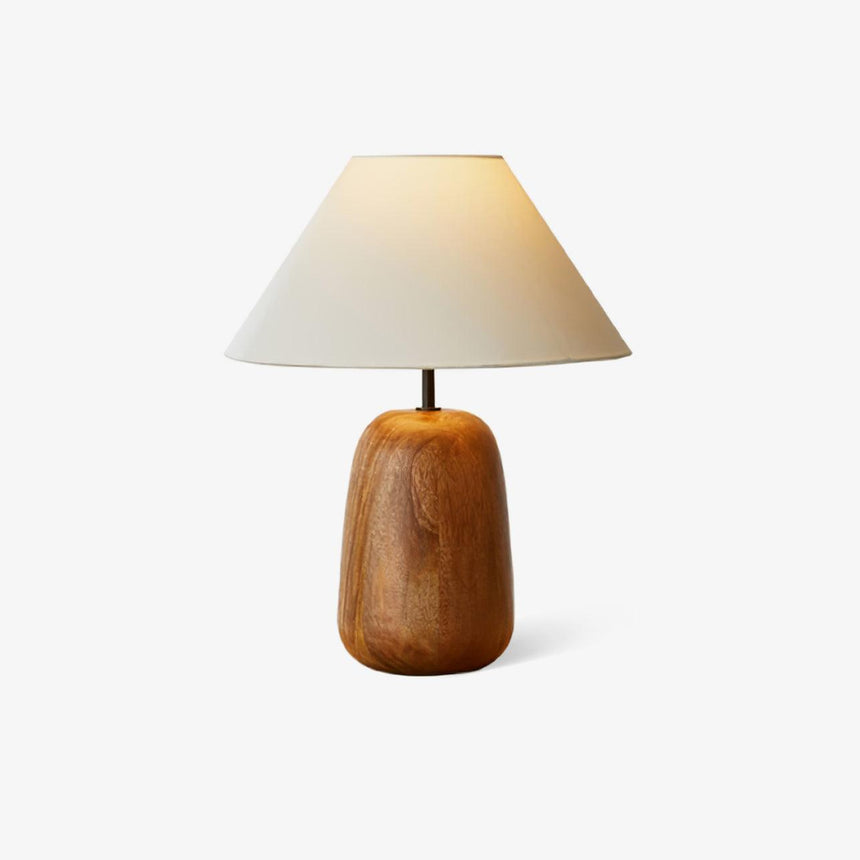 Farmhouse table lamp with a cream shade on a turned wood base, plain background