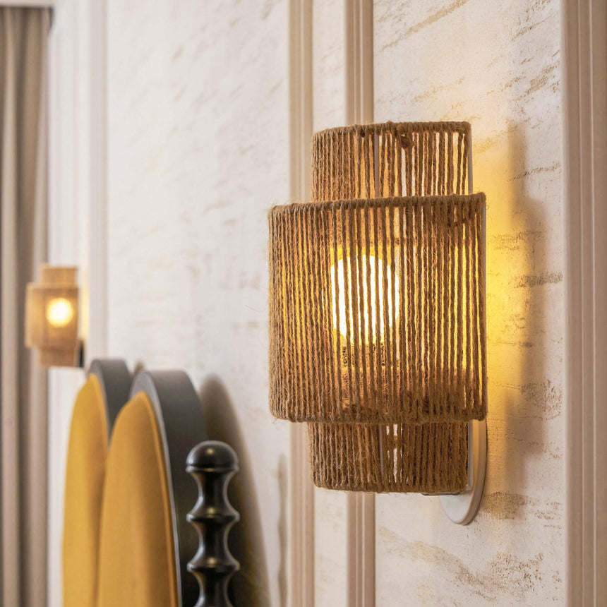 The hemp lamp lit beside a mustard headboard with a turned wood post