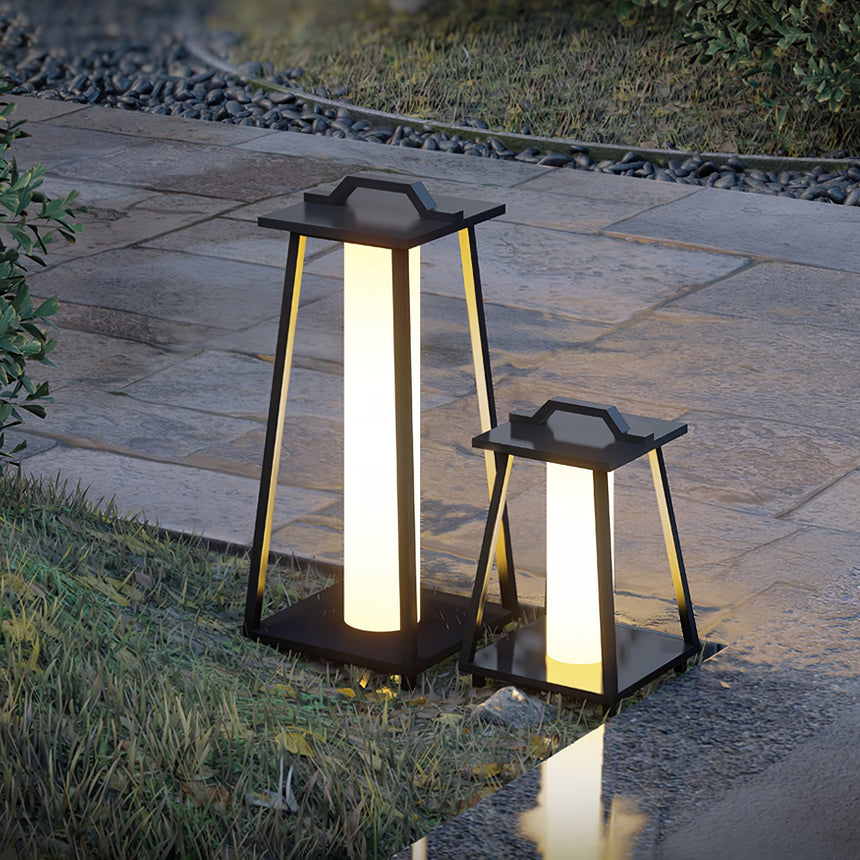 Two sizes lit on pale stone paving beside a mown lawn
