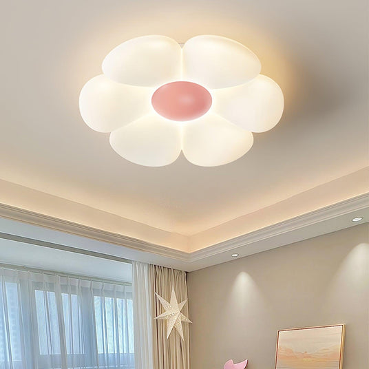 Flower ceiling light with a pink center seen close against the ceiling