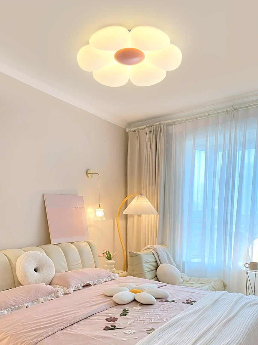 Flower ceiling light with a pink center in a bedroom with a pink rug