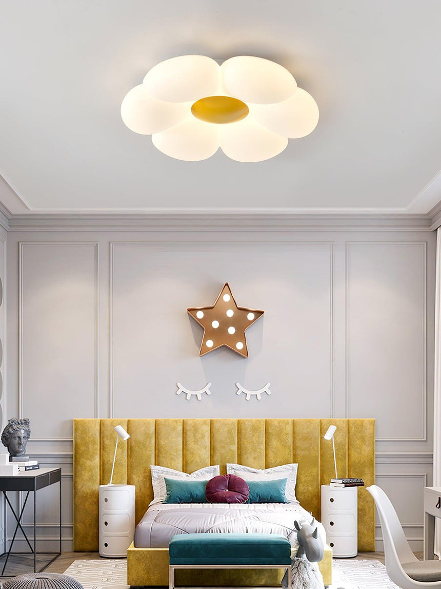 Flower ceiling light with a yellow center in a room with a star wall light
