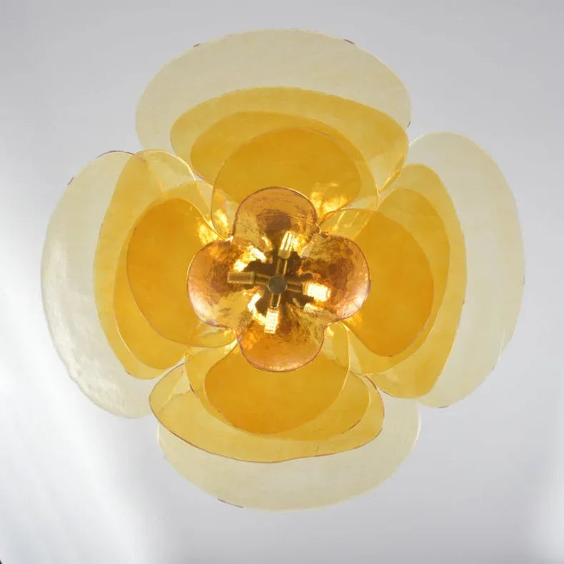 The amber petal shade seen straight from below with the lamps lit inside