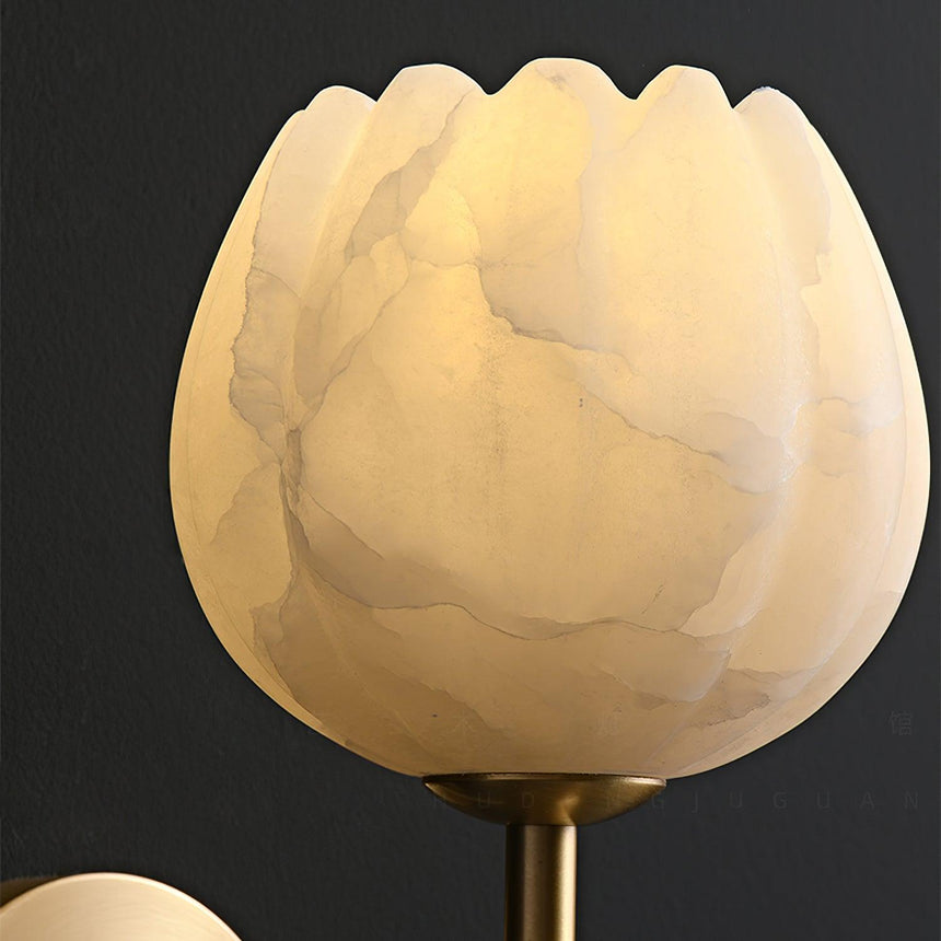 Close view of the carved stone petals lit warm against a dark background