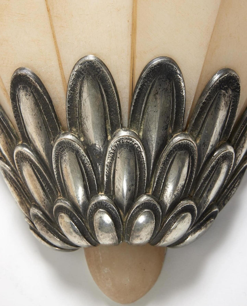 Close view of the layered metal petals under the stone fan