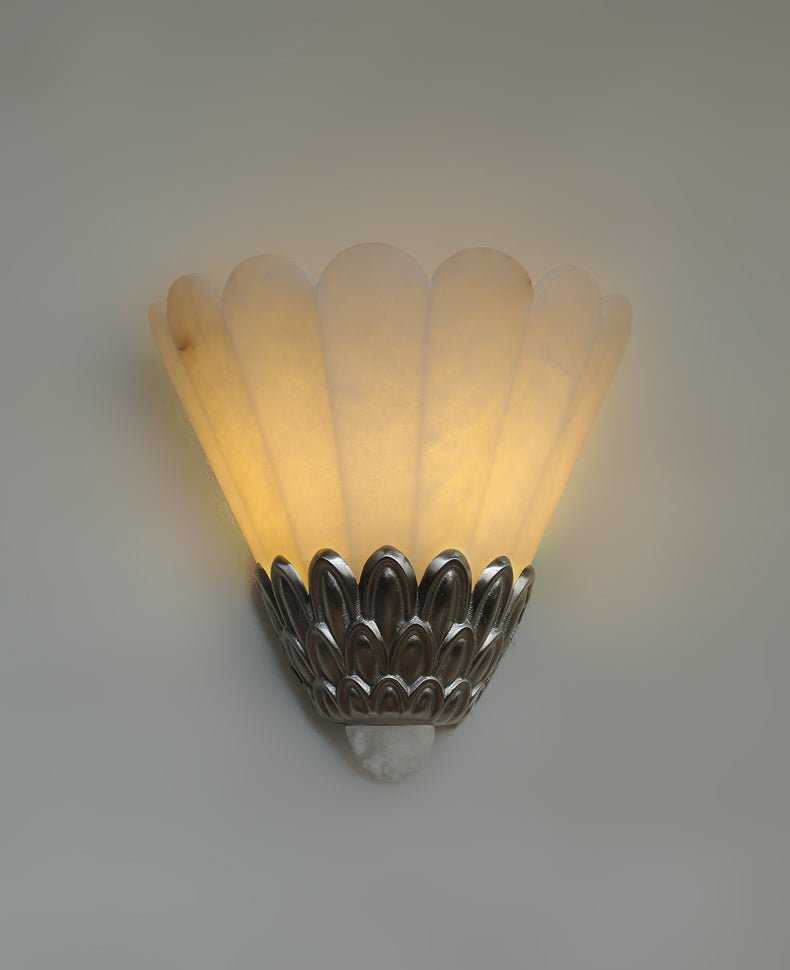 The fan shade lit warm, light rising from the metal petals