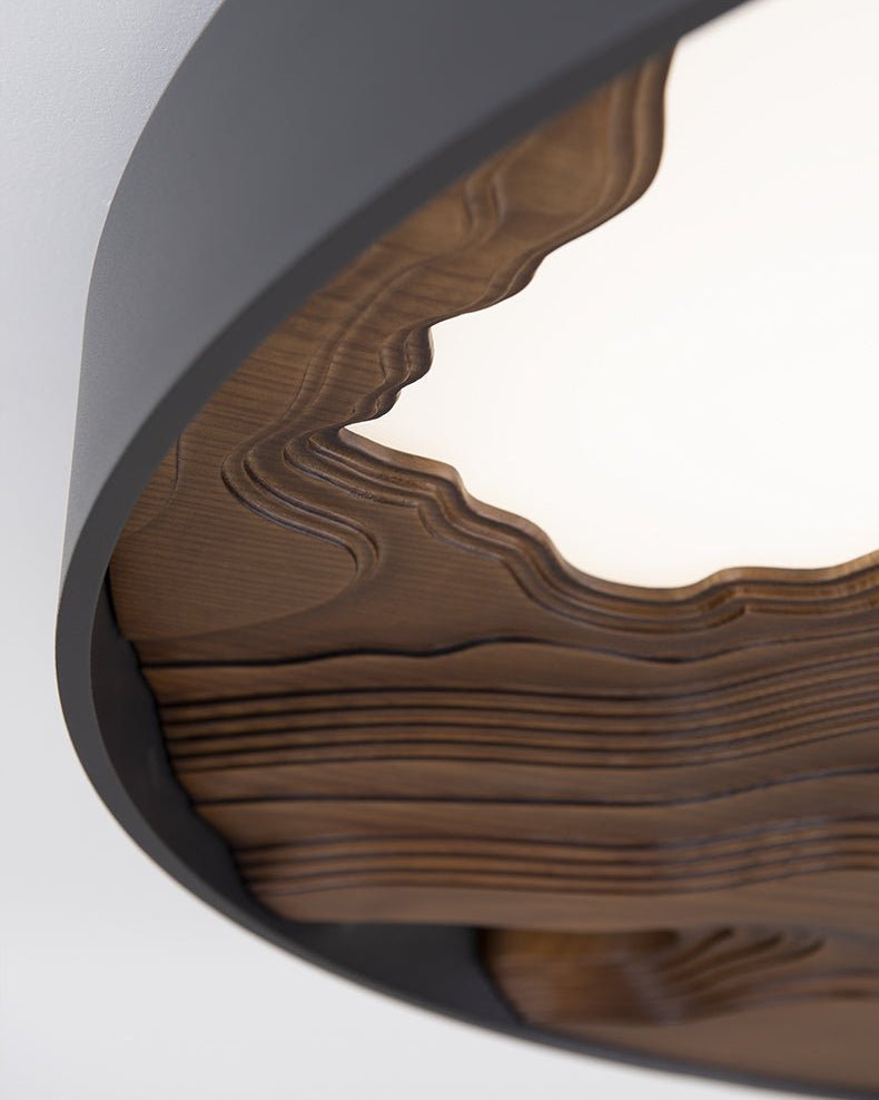 Close view of the carved wood edge where it meets the lit panel