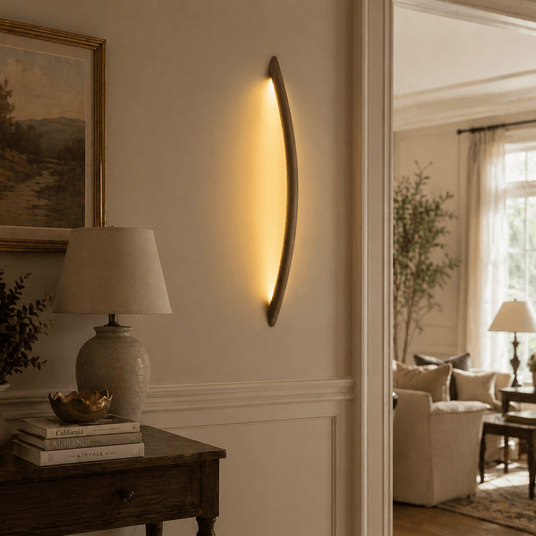 Rod lit vertically on a hallway wall beside a console and a lamp
