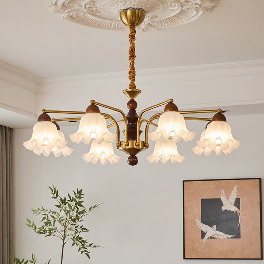 The bells lit above a dark coffee table with a pale sofa around it