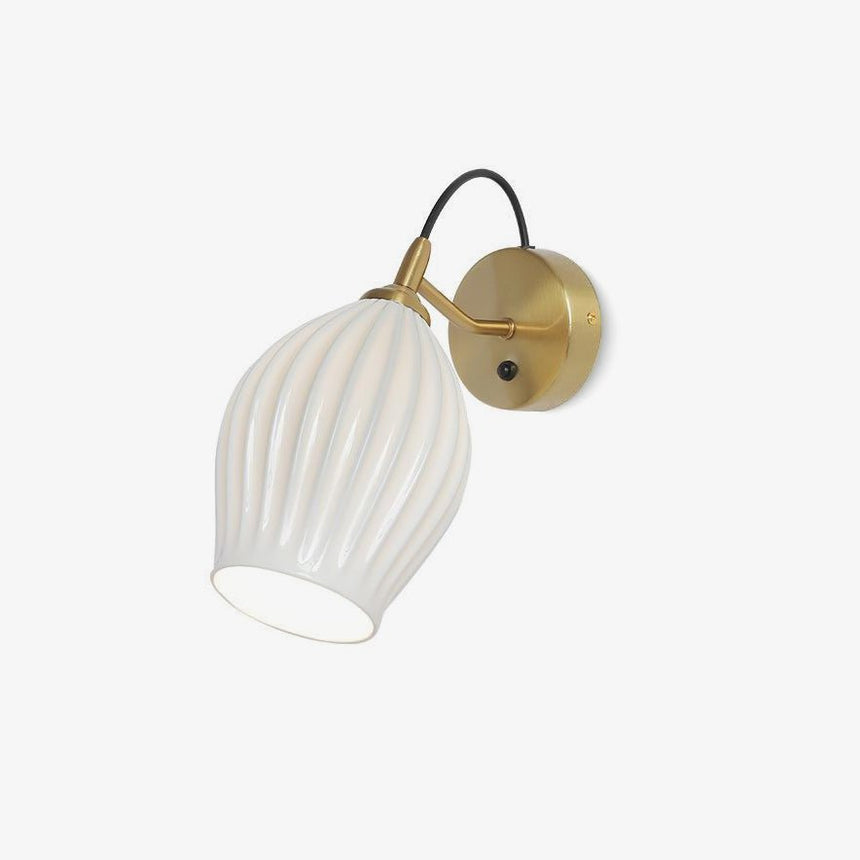 Fluted white ceramic wall sconce on a thin curved arm with a round back plate