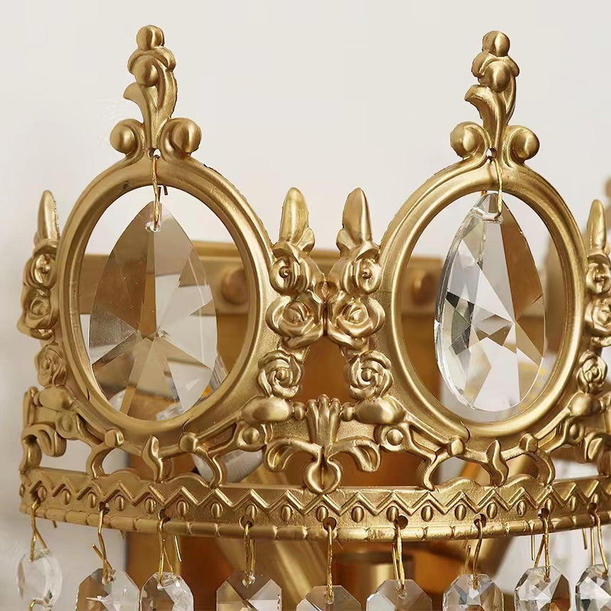 Close view of the gold crown with its round crystal medallions and scrollwork