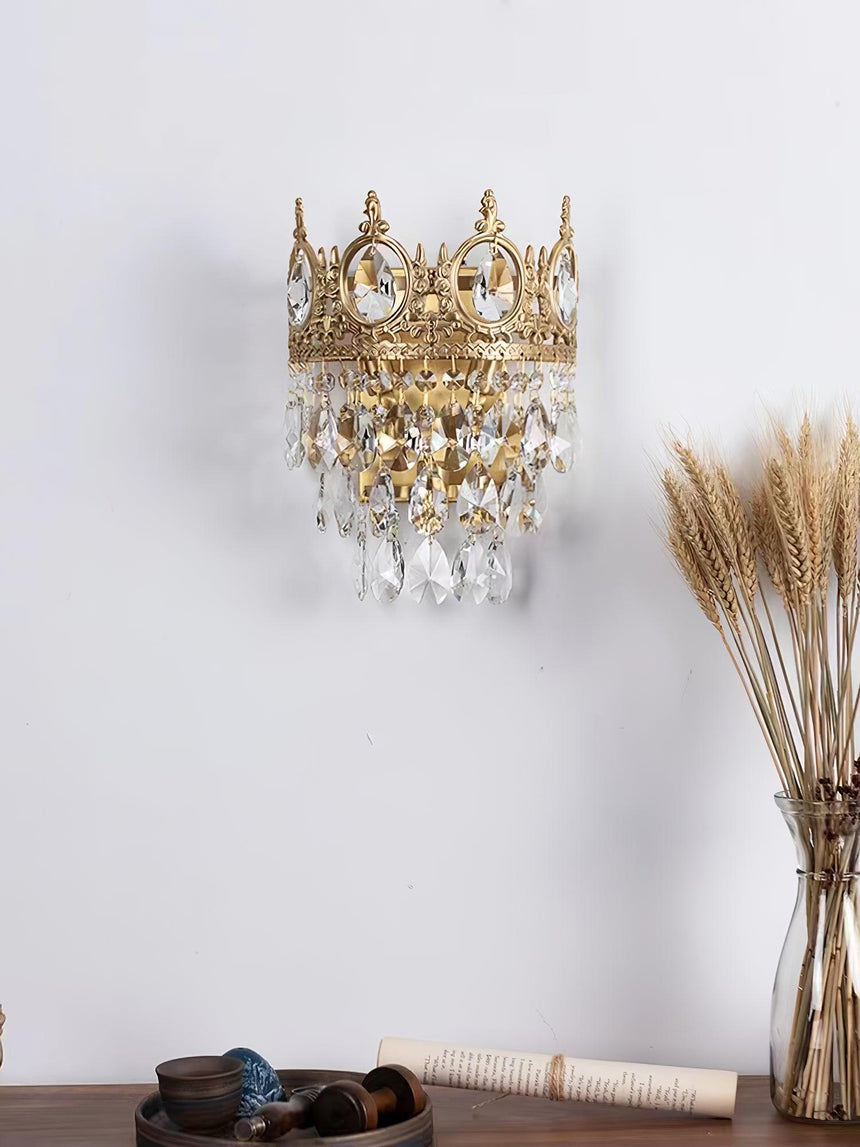 The crown lamp above a wood table with a vase of dried wheat