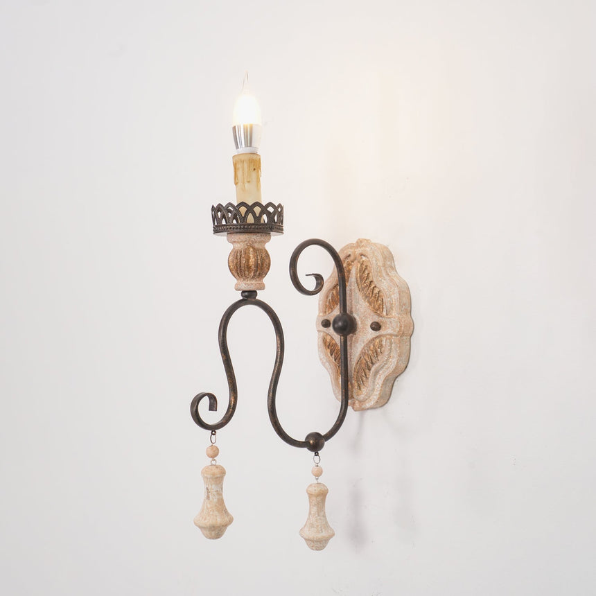 The single arm version with one carved candle cup and one hanging drop