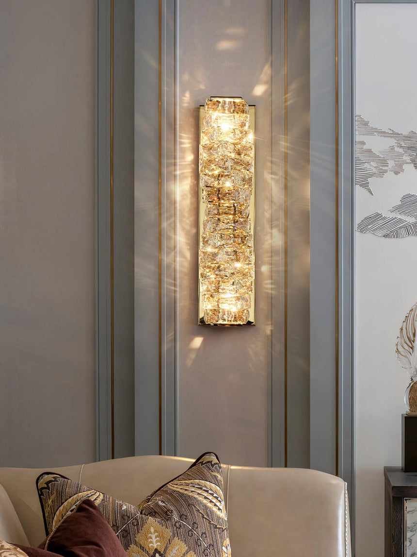The gold version lit on a paneled wall above a sofa cushion