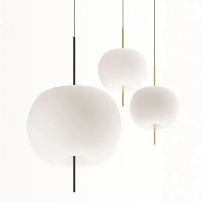 Three opal glass balls hung at different heights on slim rods