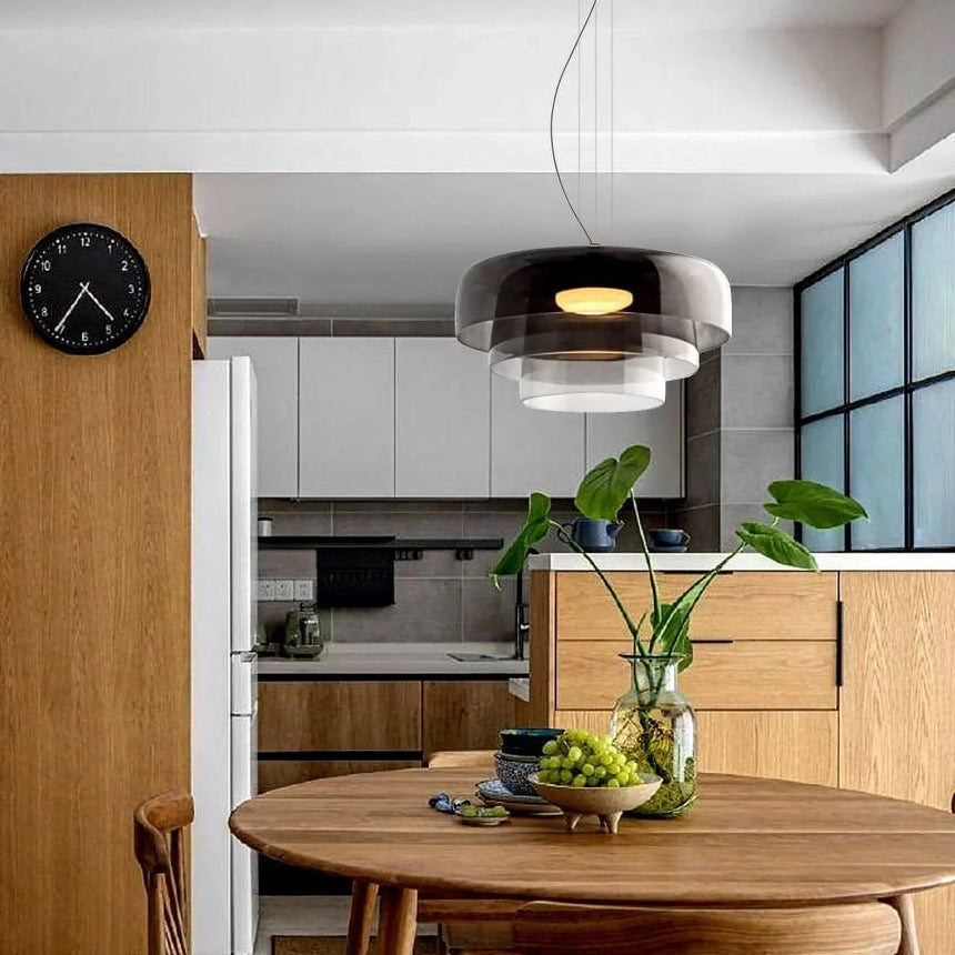 Gray stacked glass shade above a round table in a kitchen
