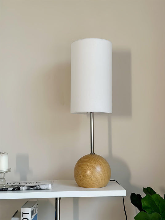 Close view of the natural wood sphere base and the slim metal stem