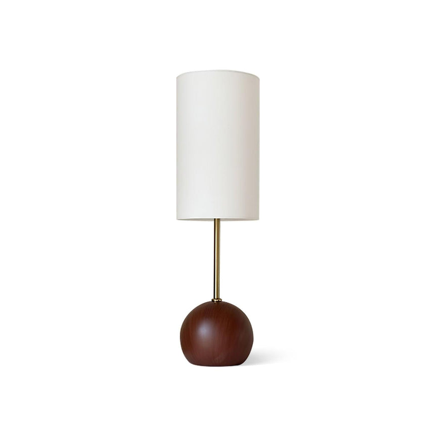 Globe table lamp with the walnut sphere seen from the front on a console