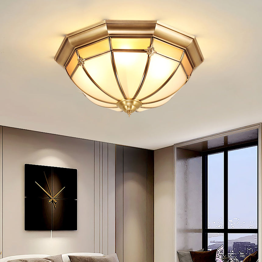 Faceted brass dome ceiling light near a dark framed window