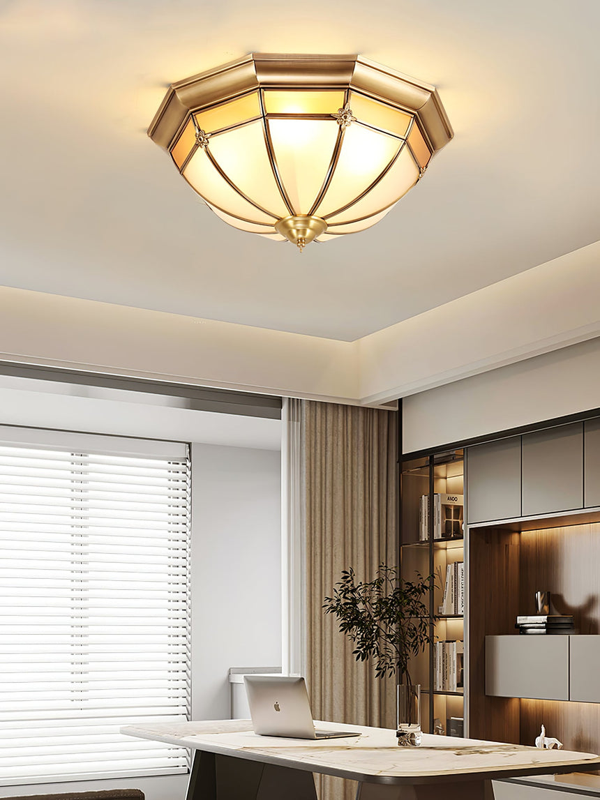 Faceted brass dome ceiling light in a room with a window and a desk