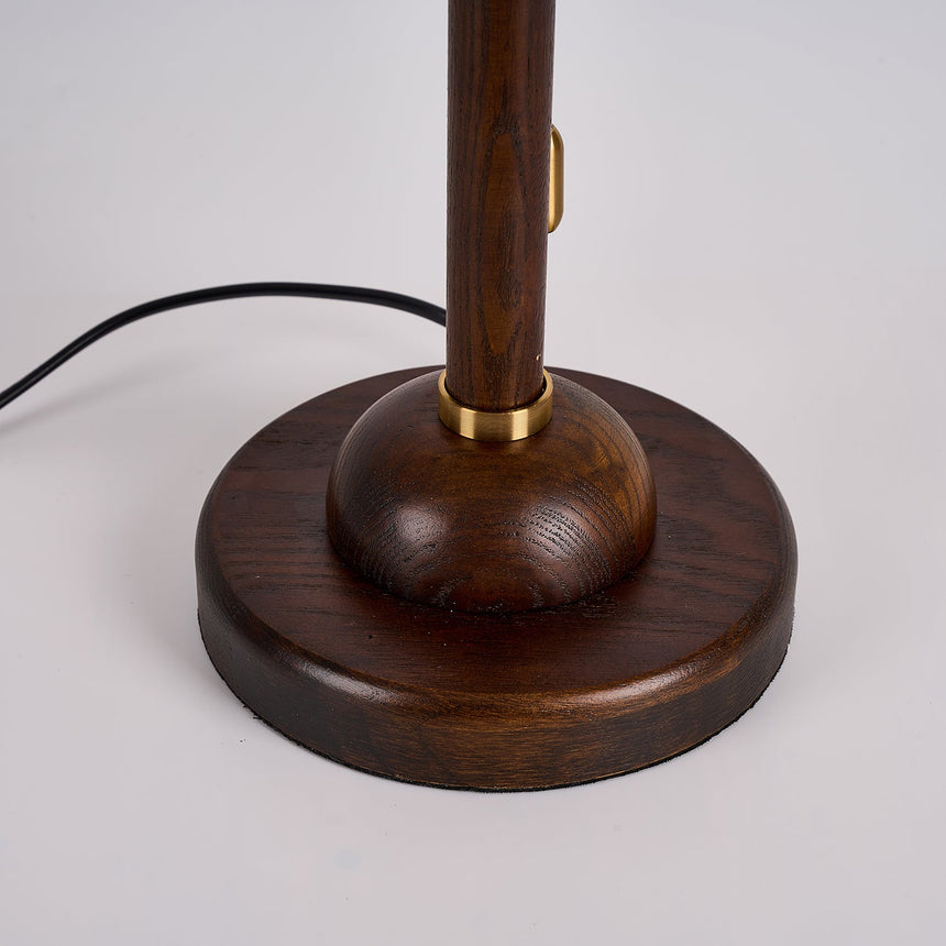 Close view of the round walnut foot and the gold collar