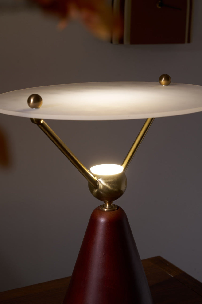 The frosted disc of the lamp seen lit from above