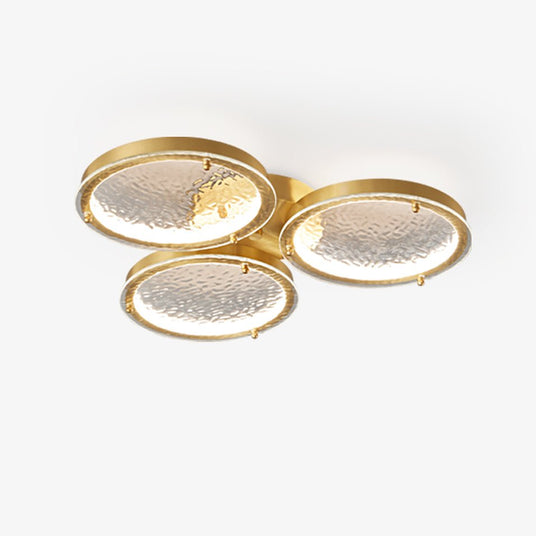 Gold LED ceiling light made of three hammered brass rings that overlap