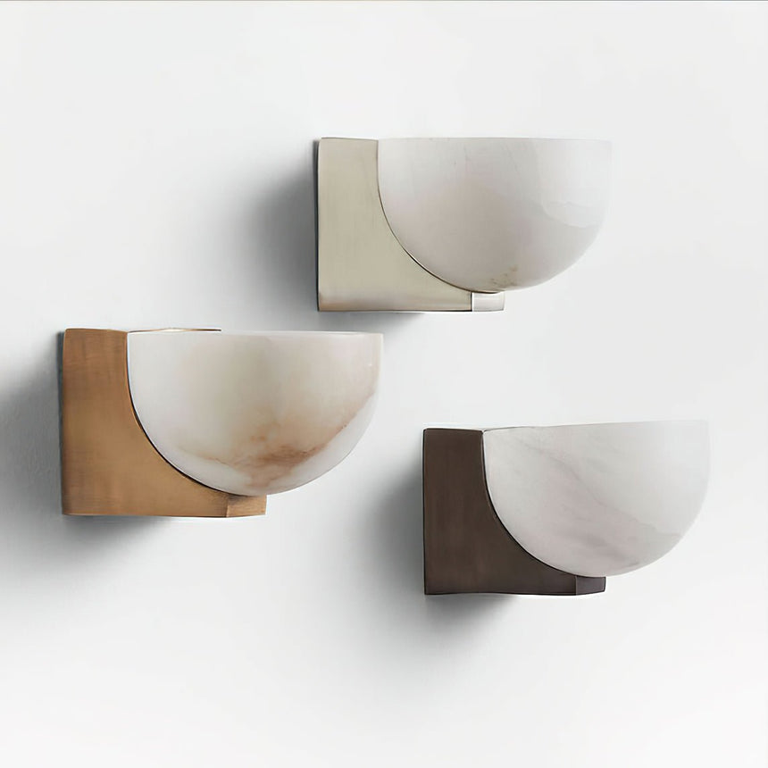 The three finishes unlit side by side, showing the stone and the plates