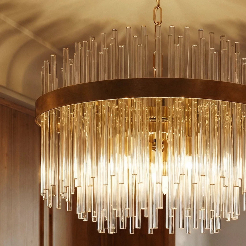 The gold ring seen close, the glass rods lit and hanging in an even fringe