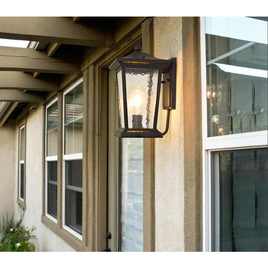 The lantern on a stucco wall under a pergola, between two windows