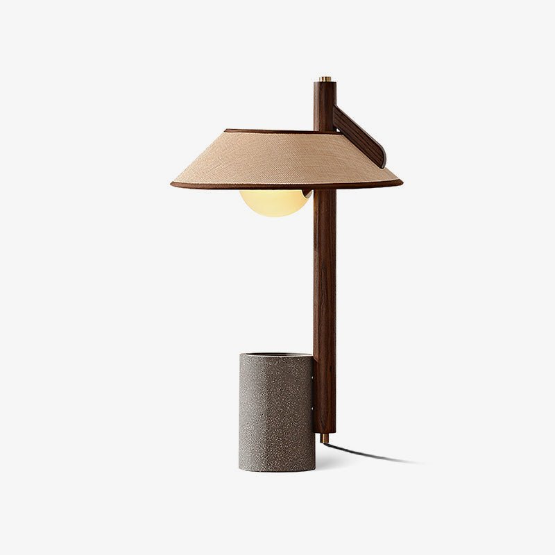 Cement base lamp seen from an angle with the shade cantilevered out