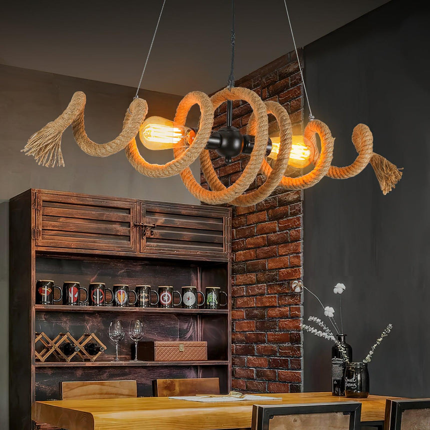 Chandelier lit in a brick room above a counter and a wine shelf