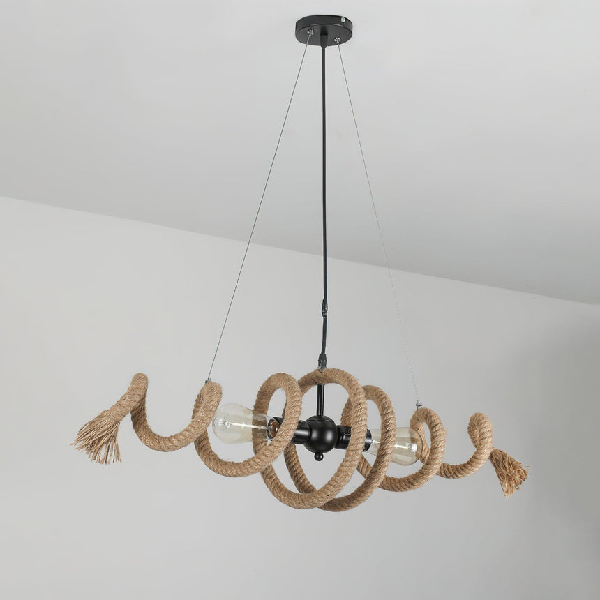 The coil hanging in a plain pale room, cables and canopy in view