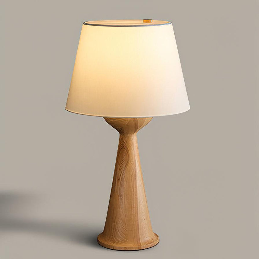 Japandi table lamp with the natural wood hourglass base, front view